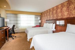 a hotel room with two beds and a television at Courtyard by Marriott Peoria in Peoria +16 photos