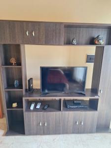 a entertainment center with a flat screen tv at Departamento Terruños in Tunuyán