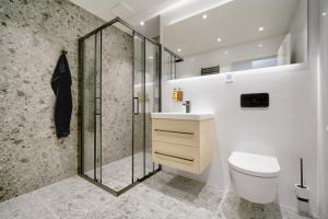 a bathroom with a shower and a toilet and a sink at apartino - FREE parking, 10 minutes walk to city centre, nespresso, netflix in Brno