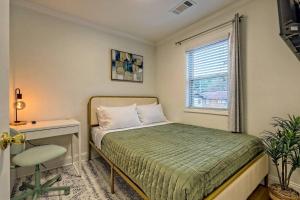 a bedroom with a bed and a desk and a window at Downtown Helen Walk To Shops And Restaurants in Helen