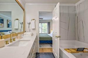 a bathroom with two sinks and a tub and a mirror at Downtown Helen Walk To Shops And Restaurants in Helen +43 photos