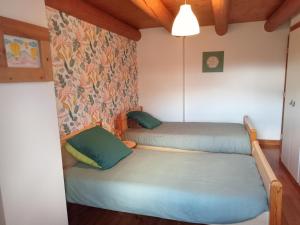 a small room with two beds in it at Gîte La Béate des Arnauds in Tiranges