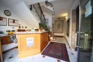 a hallway with a counter with a rug on the floor at Hotel Paris in Castel Goffredo