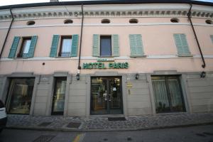 a building with a hotel fees sign on it at Hotel Paris in Castel Goffredo