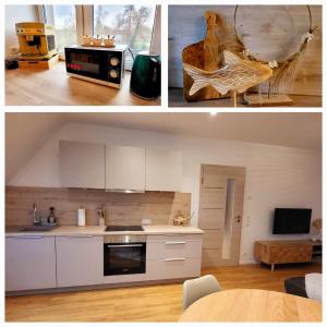 a kitchen with white cabinets and a table in a room at Flair bei Speyer in Dudenhofen