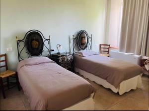 Giường trong phòng chung tại Maison Carmen