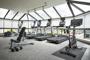 a gym with a bunch of exercise equipment in a building at Courtyard St. Louis Westport Plaza in Maryland Heights