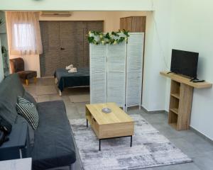 a living room with a couch and a table at Bill and Dim in Xrisoupoli in Chrysoupolis