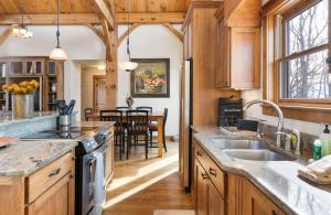 a kitchen with wooden cabinets and a dining room at Wolf Ridge Lodge in Boone +50 photos