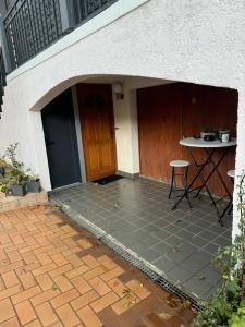 an entrance to a house with a table and a door at T2 La roseraie in Chambéry