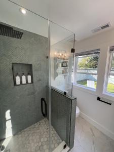 a bathroom with a shower with a glass wall at Cozy Gordonsville Cottage on Main Street in Gordonsville