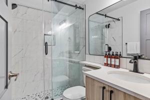 a bathroom with a shower and a toilet and a sink at Mystic Chalet- Views, Pool, Hot Tub, Pets - managed by Little Sister Getaways in Canmore