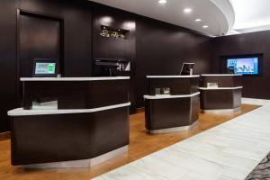 a barber shop with black walls and white counter tops at Courtyard Miami Downtown Brickell Area in Miami