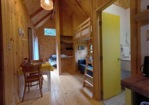a room with a table and a room with a bunk bed at Cabañas Refugio Río Roberto in Villa Santa Lucía