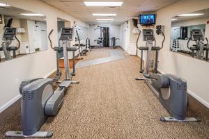 a fitness room with treadmills and tread machines at Grand Crowne Resort in Branson
