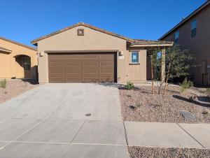 a house with a garage and a driveway at Spacious 3BR Tucson Home - Pool, Playground, Mtn View, AC in Tucson