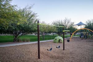 a park with a playground with a swing at Spacious 3BR Home - Pool, Playground, EV Station L2, Near Freeway, Free Parking in Tucson
