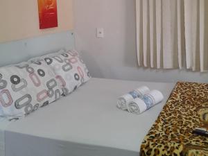 a bed with two rolls of toilet paper on it at Pousada Vale Encantado in Serra de São Bento