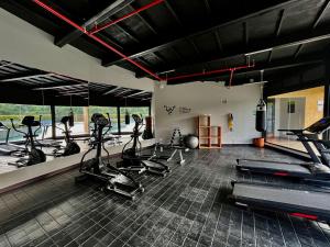 a gym with treadmills and elliptical machines at Hotel Rioverde Living Suites in San Antonio de Pereira