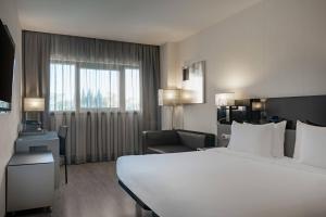 A bed or beds in a room at AC Hotel Atocha by Marriott
