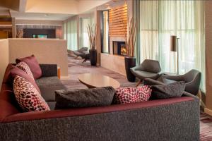 a living room with a couch with pillows at Courtyard by Marriott Rockville in Rockville