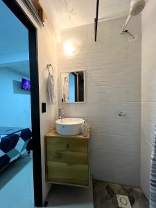 a bathroom with a sink and a mirror at Casa Magdalena N1 in San Pedro La Laguna +9 photos