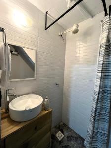 a bathroom with a white sink and a mirror at Casa Magdalena N1 in San Pedro La Laguna