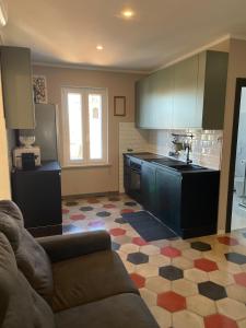 a living room with a couch and a kitchen at Il Campanile in Tivoli +12 photos