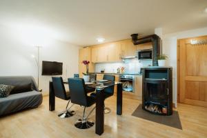 a living room with a table and a fireplace at Apartment Bergzauber in Amden +18 photos