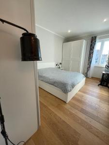 a bedroom with a bed and a wooden floor at Il Campanile in Tivoli