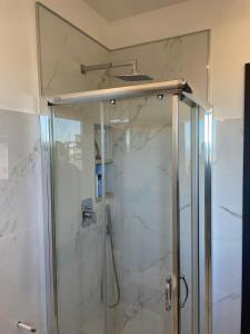 a shower stall with a glass door in a bathroom at Il Campanile in Tivoli