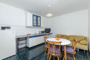 a kitchen with a table and chairs and a couch at House Goga in Primošten +12 photos