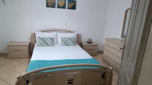 a bedroom with a bed and two night stands at Ioanna's Apartment in Potamiá