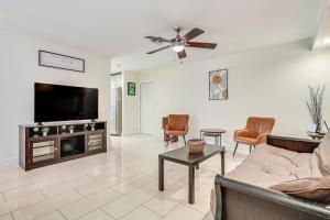 a living room with a couch and a flat screen tv at Hot Tub and Fenced Yard Pet-Friendly Miramar Haven! in Miramar