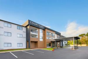 a building with a parking lot in front of it at Courtyard Mobile in Mobile