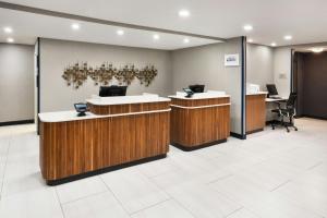 an office lobby with reception desks and chairs at Courtyard Mobile in Mobile