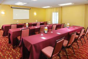 a conference room with tables and chairs and a screen at Courtyard by Marriott Oklahoma City Airport in Oklahoma City +26 photos