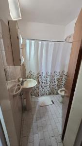 a bathroom with a sink and a toilet and a shower at Hotel San Martin in Villa María +60 photos