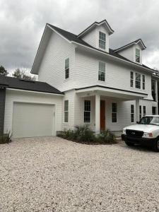 a white car parked in front of a house at Gator Grove - Colonial House - Brand New Build! in Gainesville