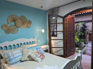 Ένα ή περισσότερα κρεβάτια σε δωμάτιο στο Recanto das Borboletas +122 φωτογραφίες