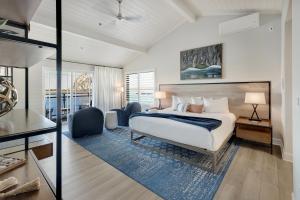 a bedroom with a bed and a desk and chairs at Anderson Inn in Morro Bay