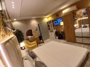 a bedroom with a bed and a living room at best rest apartments - 3 in Riyadh