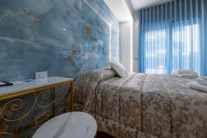 a bedroom with a bed and a blue wall at RosAmar in Bari