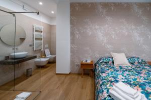 a bathroom with a bed and a sink and a toilet at RosAmar in Bari +37 photos