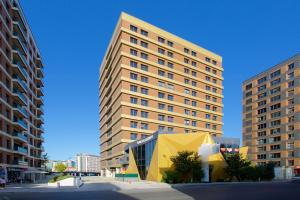a tall building with a yellow cube in front of it at Best Western Plus Hotel & Residences Istanbul in Istanbul