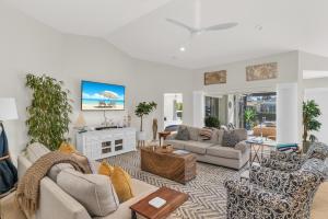a living room with couches and a fireplace at Gorgeous Waterfront 3 Bed with Quick Access to Gulf!! in Marco Island
