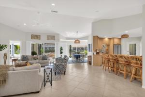 a living room and kitchen with a couch and chairs at Gorgeous Waterfront 3 Bed with Quick Access to Gulf!! in Marco Island