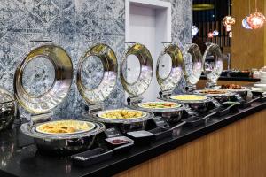a buffet line with many plates of food at Courtyard by Marriott Warsaw Airport in Warsaw