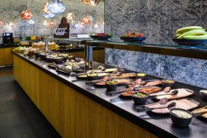 a buffet line with a lot of food on it at Courtyard by Marriott Warsaw Airport in Warsaw