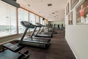 a row of exercise bikes in a fitness room at Courtyard by Marriott Warsaw Airport in Warsaw